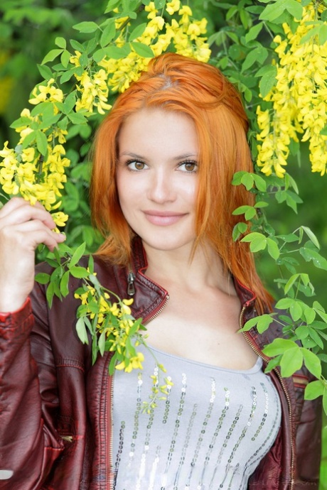 Hot redhead Violla A undressing in field to show small saggy tits & tight ass