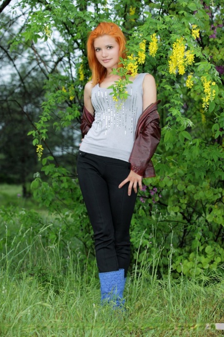Hot redhead Violla A undressing in field to show small saggy tits & tight ass