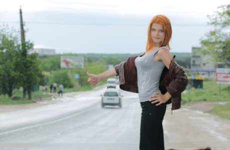 Hot redhead Violla A undressing in field to show small saggy tits & tight ass