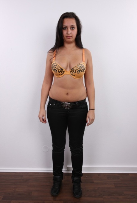 Chubby brunette Erika sits on a stool after getting completely naked