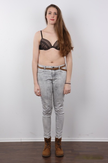 18 year old amateur Alena stands naked after removing clothes and boots
