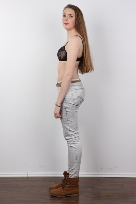 18 year old amateur Alena stands naked after removing clothes and boots