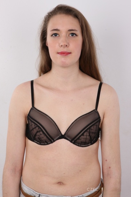 18 year old amateur Alena stands naked after removing clothes and boots