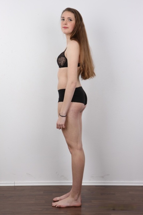 18 year old amateur Alena stands naked after removing clothes and boots