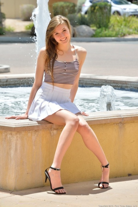 Young model gives a naked upskirt in the sun and toys both her horny holes
