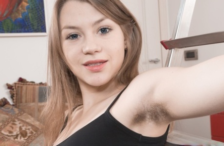 Young teen Kira Tomson lifts her tartan skirt to touch her super hairy twat