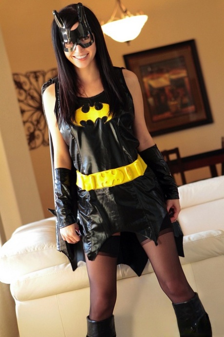 Dark haired chick Catie Minx takes off a Batman suit to model in the nude