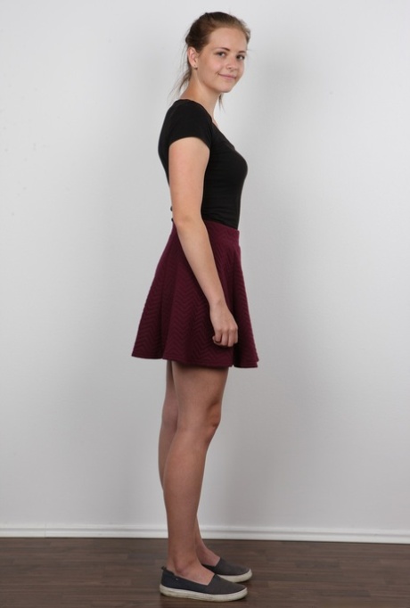 Young girl Magdalena removes her skirt and then her undergarments to pose nude