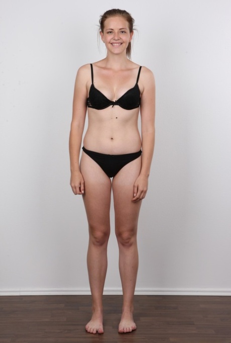 Young girl Magdalena removes her skirt and then her undergarments to pose nude