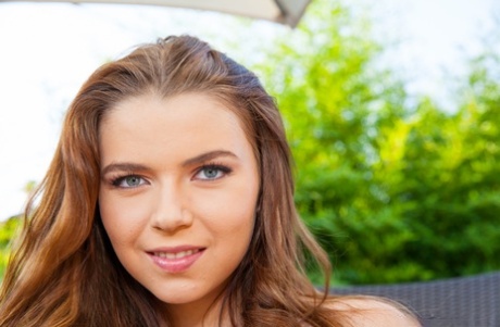 Beautiful teen Marina Visconti displays her big oil slicked boobs on a patio