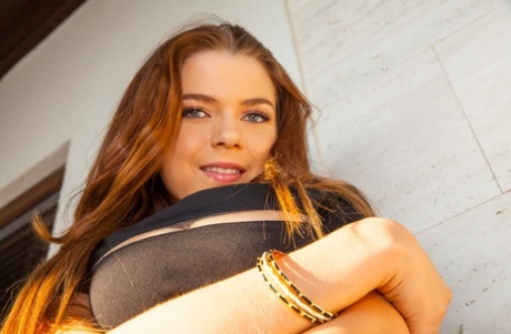 Beautiful teen Marina Visconti displays her big oil slicked boobs on a patio