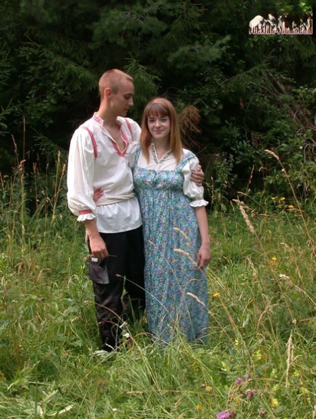 Russian teen with red hair rides her boyfriend's cock during sex in long grass