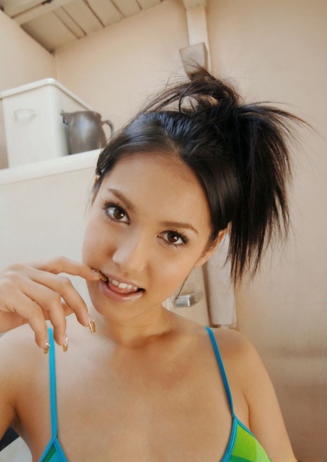 Japanese model Maria Ozawa enjoys a beverage after stripping naked