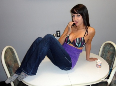 Dark haired teen Andi Land covers her tits and ass in food products