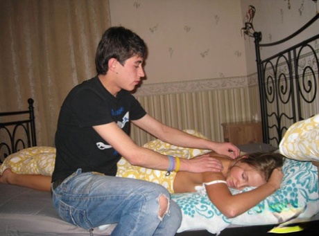 Young couple kisses during foreplay before fucking on their bed