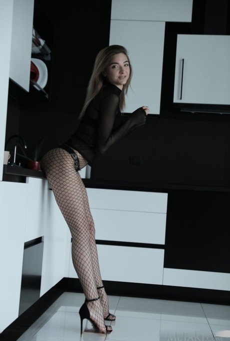 Teen model Santa removes fishnet pantyhose as she gets totally naked