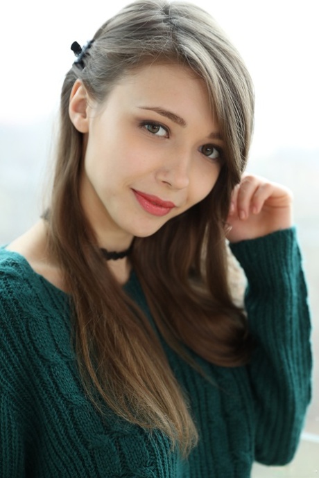Beautiful teen frees her natural tits from a sweater before spreading her twat