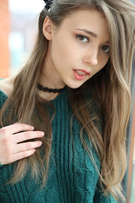 Beautiful teen frees her natural tits from a sweater before spreading her twat