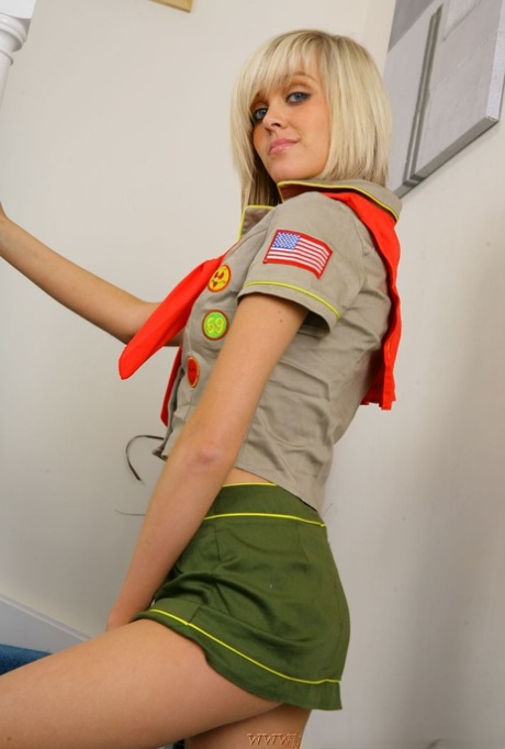 Cute blonde Jade B strips off her uniform to pose topless in panties and socks