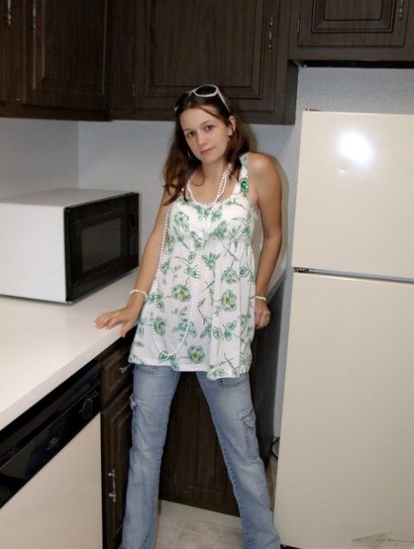 Caucasian teen slips a couple of fingers in her cunt after getting undressed
