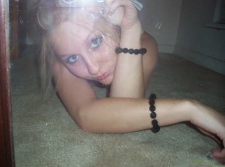 Blonde amateur Kylie takes off her brassiere in a tempting fashion