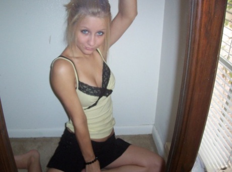 Blonde amateur Kylie takes off her brassiere in a tempting fashion