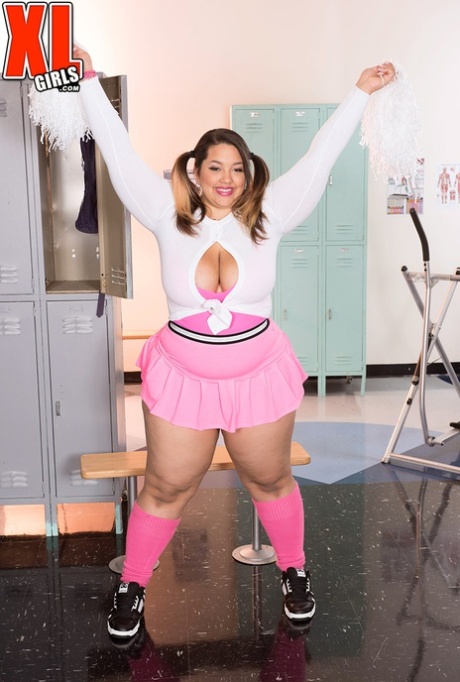 Fat cheerleader Chevy Cobain unleashes her giant breasts in a short skirt