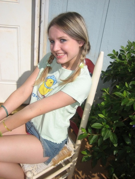 Young girl smokes a cigarette while exposing her tits and pussy
