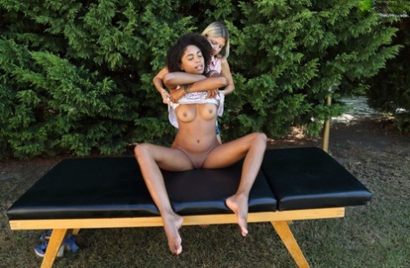 Interracial lesbians Gina Gerson & Luna Corazon have sex on a table in a yard