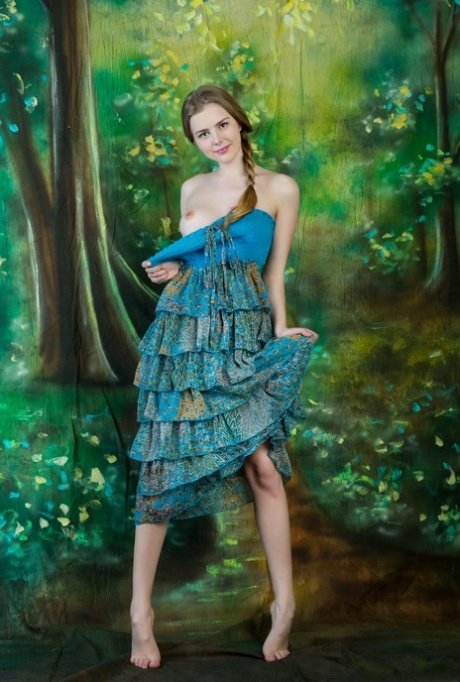 Sweet teen Marit slips off a ruffled dress to display her beautiful body