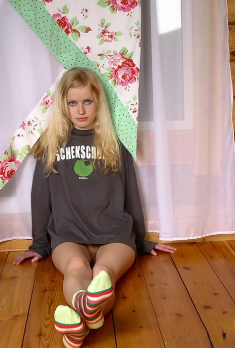 Charming blonde teen Yana F takes off a sweater to pose nude in socks