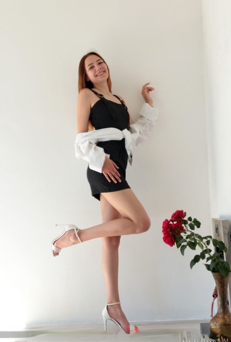 Hot redheaded teen Janey gets completely naked in a confident fashion