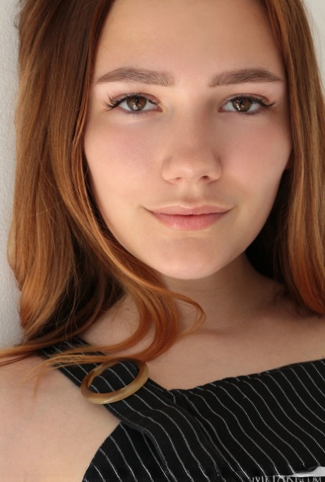 Hot redheaded teen Janey gets completely naked in a confident fashion