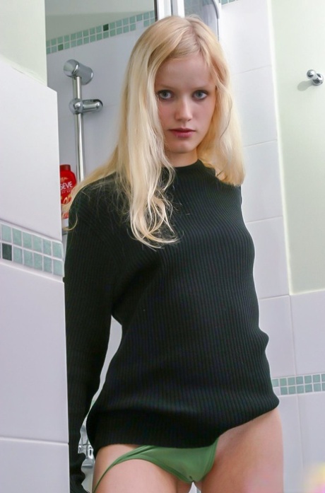 18-year-old blonde beauty Yana F gets completely naked before showering