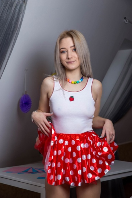 Young blonde Afina gets totally naked on a table in her bedroom