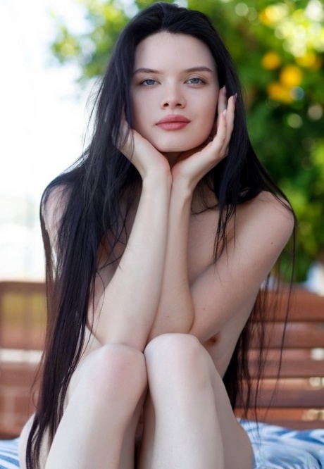 Beautiful dark haired teen Ariana Mun plays with her long hair in the nude
