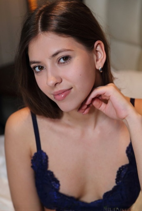 Gorgeous brunette teen Avery discards her lingerie to go nude on a bed
