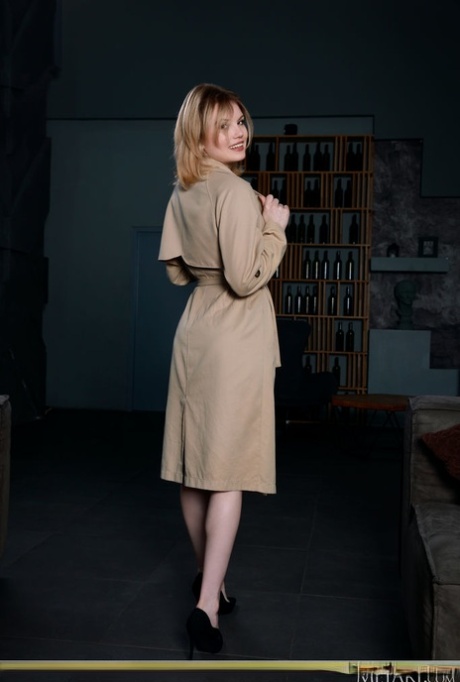Charming teen Florens flashes in an overcoat before getting naked