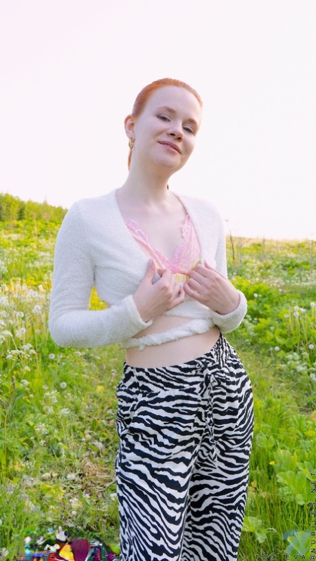 Pale redhead Fox Eva masturbates with a vibrator on a blanket in the outdoors