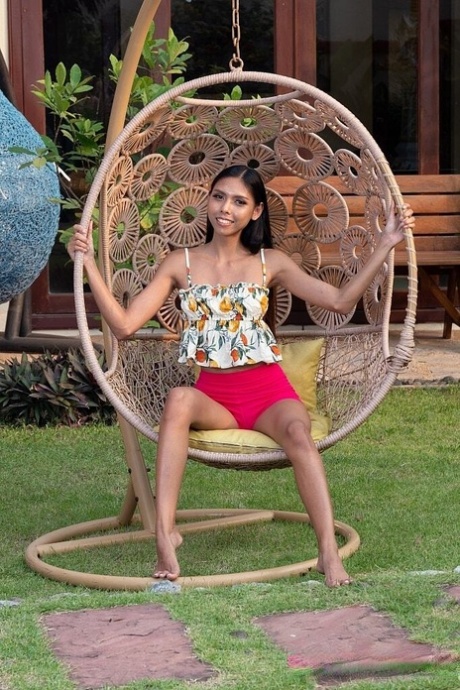 Skinny brunette teen gets totally naked in a backyard setting
