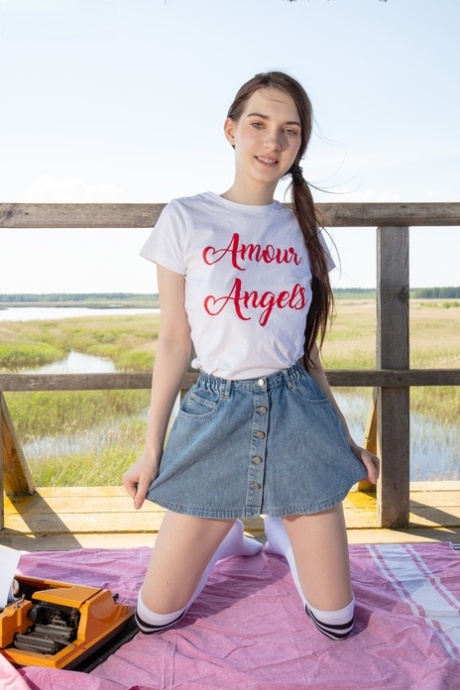 Nice teen Ernesta gets naked in over the knee sports socks at a lookout spot