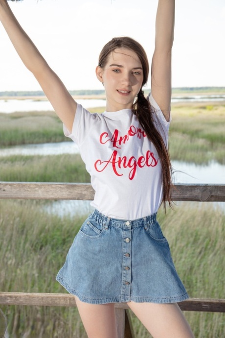 Nice teen Ernesta gets naked in over the knee sports socks at a lookout spot