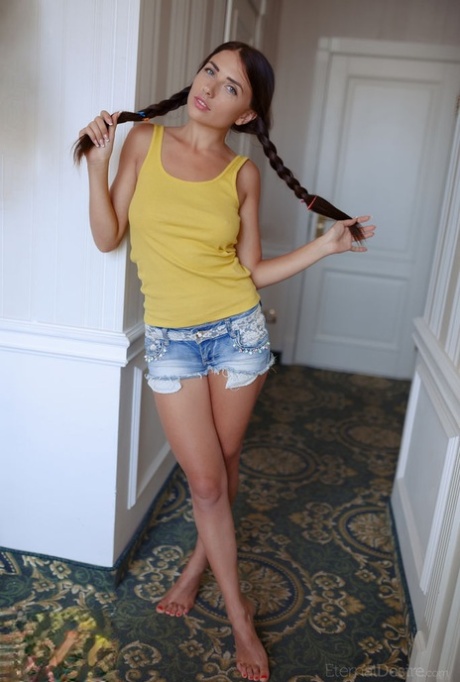 Hot brunette teen Niemira unveils her big tits while getting totally naked