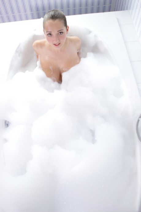 Young girl Busty Buffy pours a pitcher of milk over her knockers while bathing
