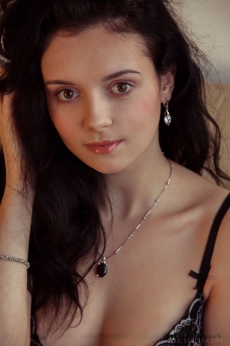Dark haired babe sliding panties over sexy teen ass during glam shoot