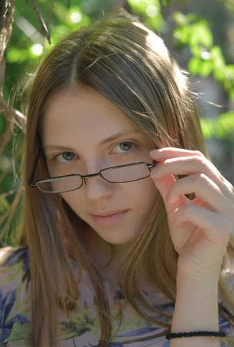 Small titted Catalina in glasses posing naked in a field showing bald muff