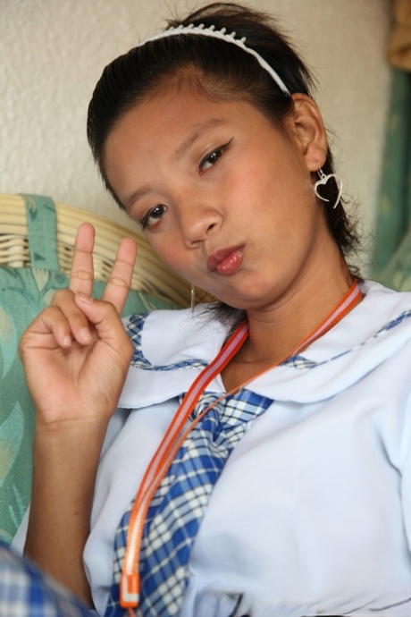 Adorable Asian schoolgirl Sally slides her cute panties aside to show her twat