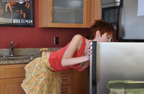Big busted redhead with unshaven twat getting rid of her clothes