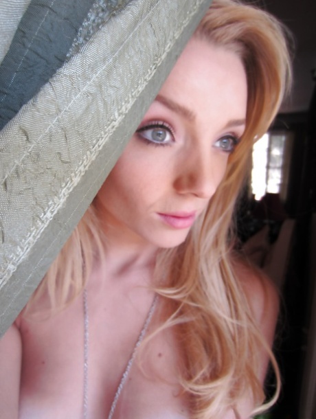 Ally Winters is spreading her slim legs wide open while masturbating