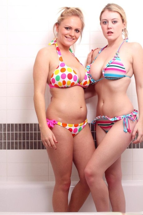 Young lesbians take off their string bikinis before showering together